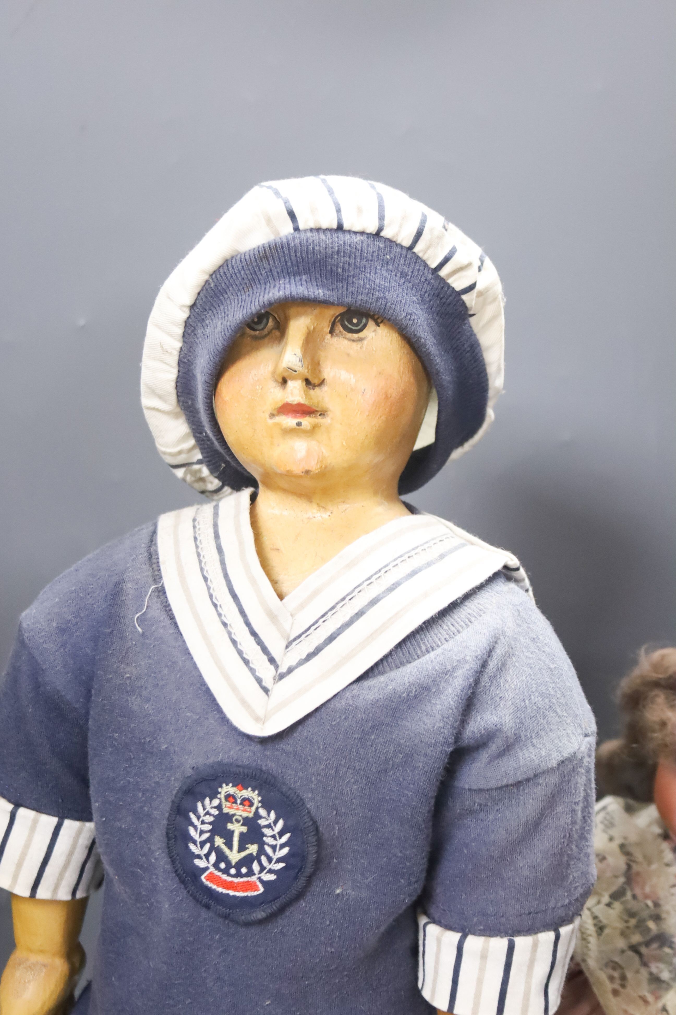 A black AM 351 cracked neck Schoneau & Hoffmeister jointed doll H13in. Black cream baby with wig crack to head H14in. two black dolls, one wood large sailor doll 20in.